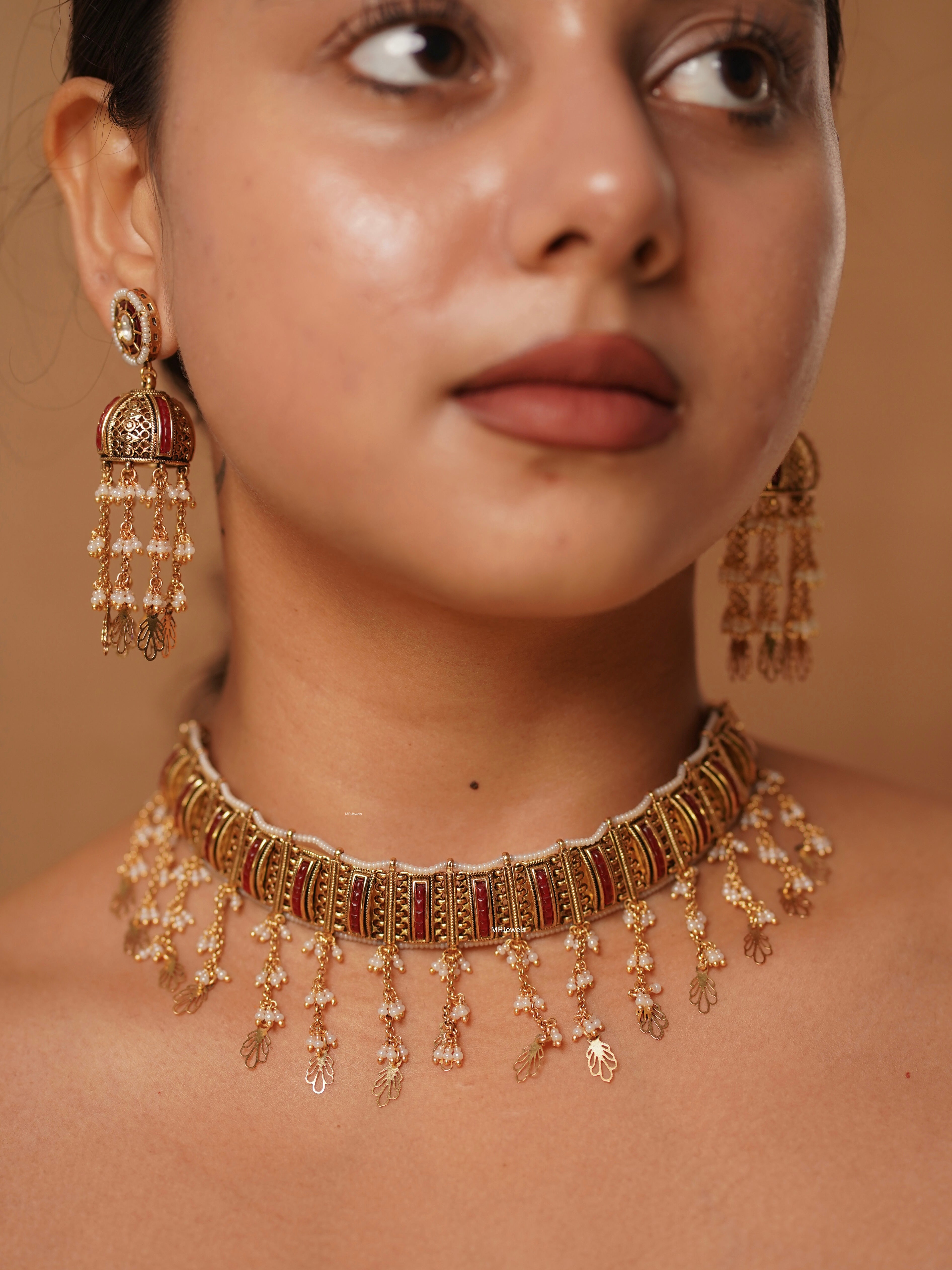 Chaandan haar choker with red enamel inlay, gold plating, and matching jhumki earrings, front view